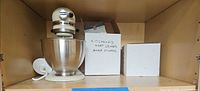 Mixer, bowl, grinder box, white box on shelf