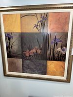 Full view of signed floral canvas painting in ornate frame