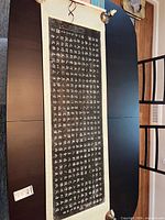 Full view of entire scroll laid out showing calligraphy rubbing and silk mounting