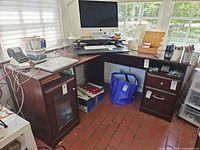 Overall view of L-shaped desk showing both wings, storage pedestals, finish color, and desktop condition
