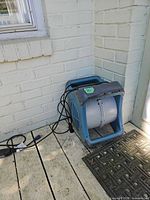 Front view of blue/gray Lasko misting fan showing open discharge and overall condition