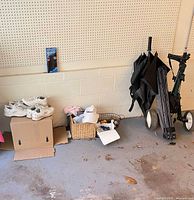 Overall lot showing push cart, umbrella, shoes, baskets and accessories
