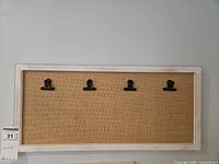 Full view of bulletin board showing frame, fabric, and all clips