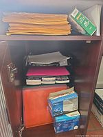 Cabinet shelf with manila envelopes stack, Mead and Columbian envelope boxes