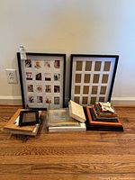 Group view of all frames leaning against wall and stacked on floor