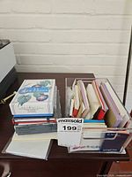 Lot overview showing acrylic organizer filled with journals and sticky pads, boxed note cards stacked beside