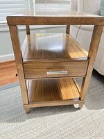 Front view showing top, open shelf, drawer, bottom shelf, finish