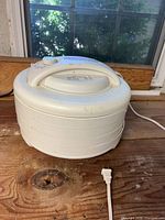 Stacked dehydrator with four trays, power cord visible