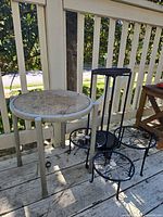 All five pieces on deck: round mesh table, four-tier stand, three small stands