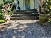 Both concrete urns flanking steps showing overall size and style