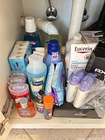 Group view of assorted toiletries under sink