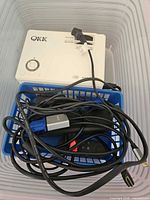 Top view of QKK QK01 projector and cables in bin