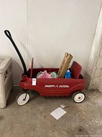 Side view of red Radio Flyer pull wagon loaded with accessories