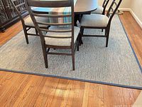 rug under dining set showing overall size and blue border