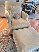 Full view of armchair, ottoman, cushions, pillow