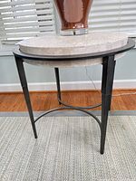 Full view of side table showing travertine top and metal legs