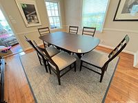 Dining table with six chairs on rug