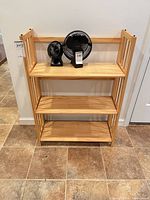 Front view of pine bookcase showing three shelves and slatted sides