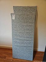 Both cushions leaning against wall showing pattern and size difference