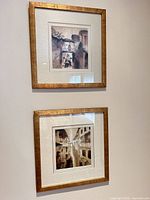 Two framed watercolors mounted vertically on wall