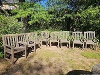 All eight teak armchairs arranged outdoors