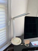 Lamp at desk, arm folded, overall view