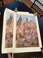 Two Penley collage prints laid on table showing full artwork