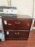 Front view showing two drawers, handles, overall cabinet
