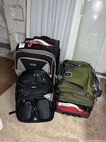 Group shot of Totes suitcase, Pathfinder suitcase, Mobile Edge backpack, olive duffel