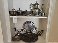 Full view of all silver plated pieces on shelf
