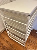 Entire storage unit showing four baskets and top
