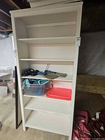 Front view of white bookcase with five shelves