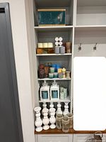 Full view of shelving showing all candles, lanterns, holders and box