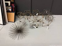 Group of metal polyhedron sculptures and starburst orbs