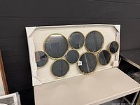 Front view showing full multi-circle mirror on cardboard backing