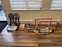 Entire lot overview including sports items, games, stools