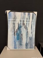 Front view of framed abstract artwork, blue and grey tones