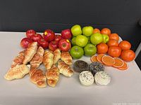 Tabletop view of all artificial fruits and baked goods