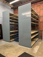 two tall grey-sided shelving units showing overall size and tiers