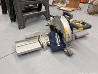 Top angled view of Mastercraft Maximum mitre saw showing blade guard, dust bag, and extension wings