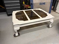 Coffee table angled view showing glass panels and legs