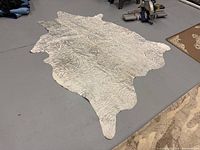 Full view of zebra print faux hide rug on floor