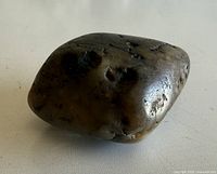 Overall view of smoothed stone showing surface pits