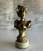 front view of gilded bust on marble base