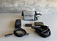 Full lot showing camcorder, remote, battery, tape, A/V cable, power cord