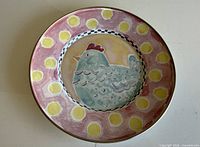 Front view showing rooster design and rim pattern