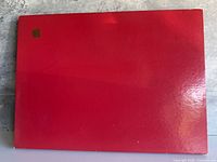 Red glossy slipcase front with embossed Apple logo