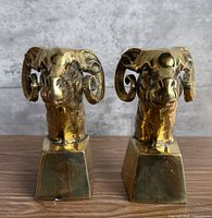 Front view of both brass ram head bookends