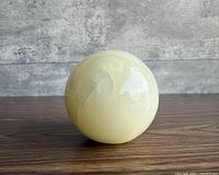 Front view of polished golden quartz sphere