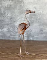 Front left view of pink glass flamingo showing body shape and color